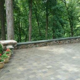 Stone Patio & Rustic Wall — Stone patio with rustic wall and forest backdrop.